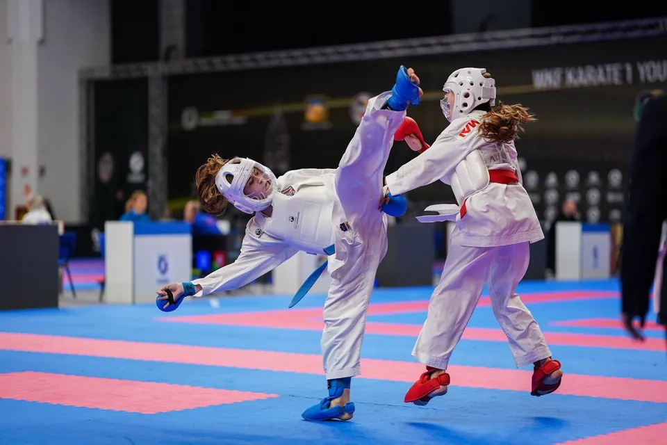 Kumite: kids in headgear trade kicks