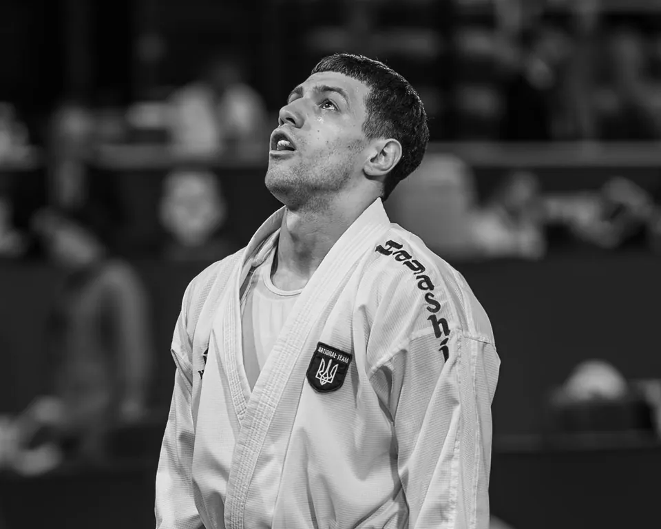 A Ukrainian national team karateka looks up, black and white