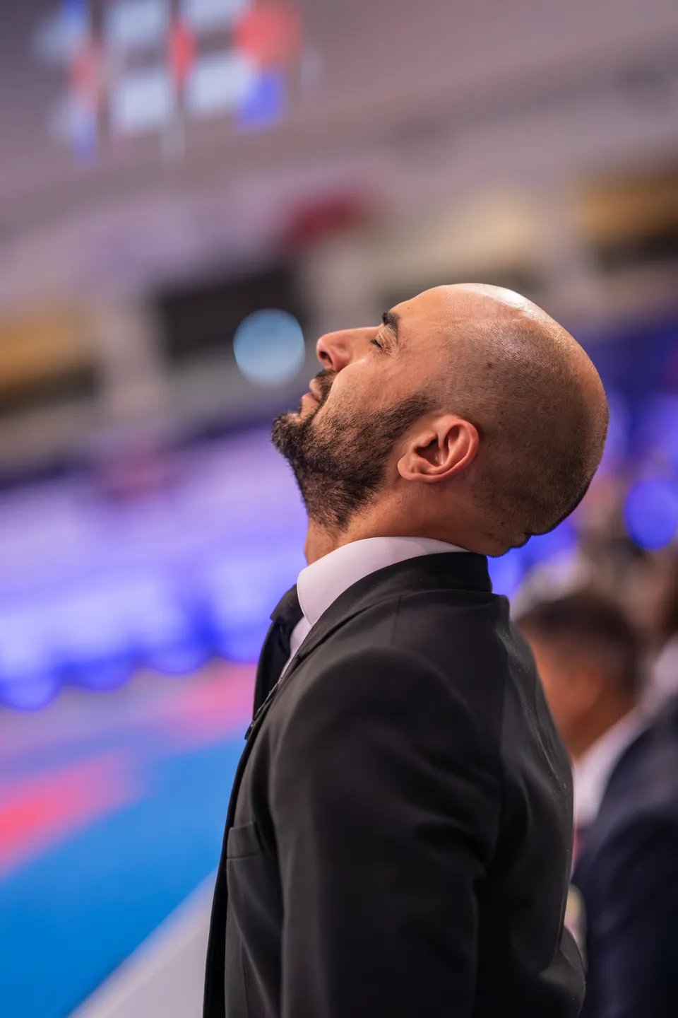A coach looks up at the scoreboard