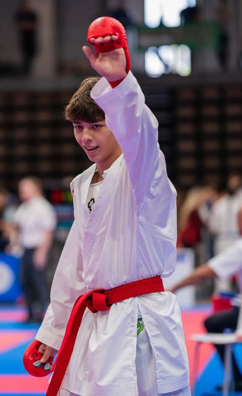 Kumite: an athlete raises his hand after the bout