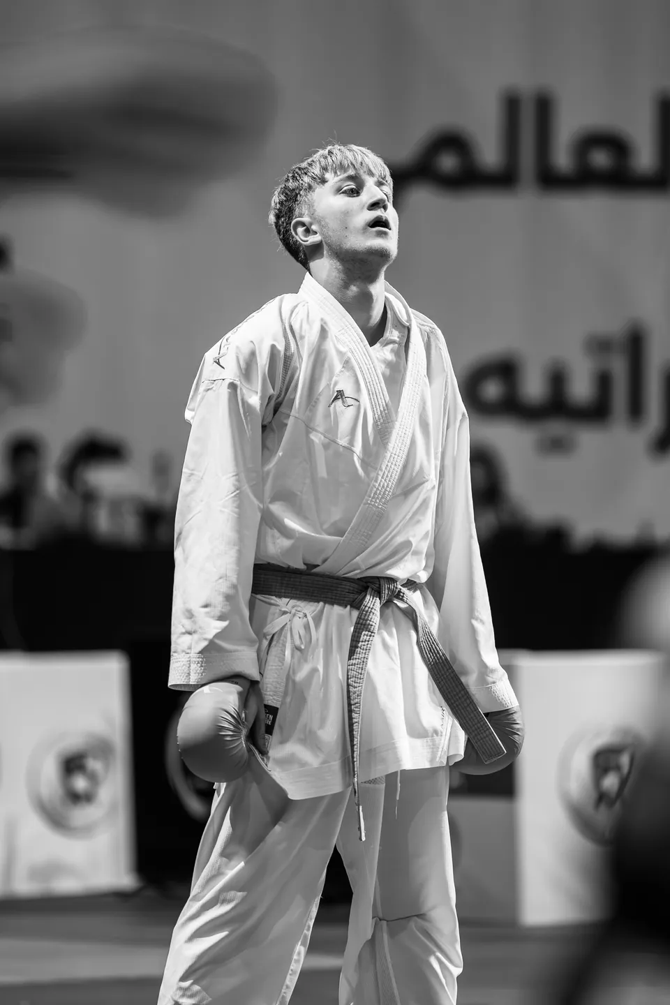 An athlete awaits the judges' decision, black and white